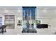 Contemporary living space featuring a glass wine rack, marble flooring, and modern appliances in the adjacent kitchen at 49 Interlaken Rd, Orlando, FL 32804