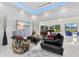 Well-lit living area showcases modern furniture, stylish décor, and an open layout connecting to a billiards room at 49 Interlaken Rd, Orlando, FL 32804