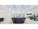 Spacious living room with marble flooring, recessed lighting, and modern decor, adjacent to a game room at 49 Interlaken Rd, Orlando, FL 32804