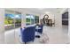 Inviting living room with two blue armchairs and sliding doors opening to a patio area at 49 Interlaken Rd, Orlando, FL 32804