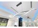 View of the modern chandelier with gray kitchen cabinets and a modern wine rack at 49 Interlaken Rd, Orlando, FL 32804