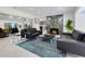 Elegant living room with designer furniture, a striking fireplace, and an open view to the kitchen at 49 Interlaken Rd, Orlando, FL 32804