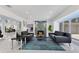 Bright living room featuring stylish furnishings, a modern fireplace, and a glimpse into the adjacent kitchen at 49 Interlaken Rd, Orlando, FL 32804