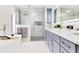 Elegant bathroom with double sink vanity, soaking tub, and frameless glass shower at 49 Interlaken Rd, Orlando, FL 32804