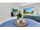Bedroom with backyard views, sleek dresser with TV, a potted plant, and stylish center table at 49 Interlaken Rd, Orlando, FL 32804