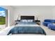 Modern bedroom with a large bed, marble floors, and bright lighting at 49 Interlaken Rd, Orlando, FL 32804