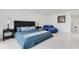 Bright bedroom with a large bed, marble floors, and chic blue lounge furniture at 49 Interlaken Rd, Orlando, FL 32804
