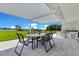 Covered patio with dining area and outdoor grill, perfect for entertaining and enjoying lake views at 49 Interlaken Rd, Orlando, FL 32804