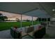 Covered patio with ample seating and serene lake views provides the perfect space for outdoor enjoyment at 49 Interlaken Rd, Orlando, FL 32804