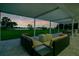 Covered patio with ample seating and serene lake views provides the perfect space for outdoor enjoyment at 49 Interlaken Rd, Orlando, FL 32804