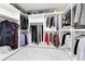 Spacious walk-in closet with organized shelving, hanging rods, and marble floors at 49 Interlaken Rd, Orlando, FL 32804