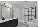 Bathroom featuring a black framed shower, black faucet, gray wood flooring, and tiled shower at 4940 Spring Run Ave, Orlando, FL 32819