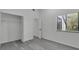 Bedroom with grey wood flooring and a modern closet at 4940 Spring Run Ave, Orlando, FL 32819