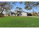 Exterior shot of a home featuring a well-maintained lawn, black and white trim, and a two-car garage at 4940 Spring Run Ave, Orlando, FL 32819