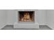 Elegant white fireplace with a fire burning, adding a cozy touch to the living space at 4940 Spring Run Ave, Orlando, FL 32819