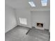 Bright living room featuring skylights, a fireplace, and hardwood flooring at 4940 Spring Run Ave, Orlando, FL 32819