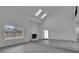Spacious living room with vaulted ceilings, skylights, a fireplace, and light gray wood floors creating an inviting atmosphere at 4940 Spring Run Ave, Orlando, FL 32819