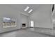 Spacious living room with vaulted ceilings, skylights, a fireplace, and light gray wood floors creating an inviting atmosphere at 4940 Spring Run Ave, Orlando, FL 32819