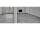 Bright living room showcasing a fireplace, light gray wood floors, and a large window for natural light at 4940 Spring Run Ave, Orlando, FL 32819
