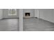 Bright living room showcasing a fireplace, light gray wood floors, and a large window for natural light at 4940 Spring Run Ave, Orlando, FL 32819
