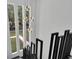 Staircase featuring a black railing and a modern decorative pendant light at 4940 Spring Run Ave, Orlando, FL 32819