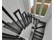 Staircase featuring a black railing and gray wood stairs at 4940 Spring Run Ave, Orlando, FL 32819