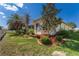 Exterior view of a well-maintained home surrounded by lush, mature landscaping at 5007 Belted Kingfisher Dr, Oxford, FL 34484