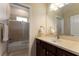 Bright bathroom featuring a vanity with neutral countertop, dark wood cabinets, and a shower-tub combo at 5007 Belted Kingfisher Dr, Oxford, FL 34484