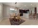 Cozy dining area with a glass table, elegant chairs, and a view of the modern kitchen at 5007 Belted Kingfisher Dr, Oxford, FL 34484