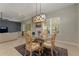 Bright dining room featuring a glass table, ornate chairs, and a view of the living room at 5007 Belted Kingfisher Dr, Oxford, FL 34484