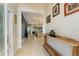 Bright foyer with tiled floors leads to a spacious living area, accented with a wooden console table at 5007 Belted Kingfisher Dr, Oxford, FL 34484