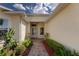 Inviting front entrance with a brick path surrounded by vibrant landscaping at 5007 Belted Kingfisher Dr, Oxford, FL 34484