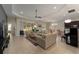Spacious living room with tile flooring, a ceiling fan, and sliding glass doors to the screened in porch at 5007 Belted Kingfisher Dr, Oxford, FL 34484