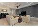 Well-lit living room with tile floors, comfortable seating, neutral paint, and a flat screen tv at 5007 Belted Kingfisher Dr, Oxford, FL 34484
