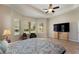 Large primary bedroom featuring tiled floors, ceiling fan, and neutral walls, creating a serene retreat at 5007 Belted Kingfisher Dr, Oxford, FL 34484