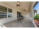 Covered patio featuring ceiling fans, herringbone tile and access to the home through sliding doors at 5007 Belted Kingfisher Dr, Oxford, FL 34484