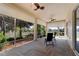 Relaxing screened patio with herringbone tile, ceiling fans, and views of the landscaped yard at 5007 Belted Kingfisher Dr, Oxford, FL 34484