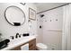 Bright bathroom featuring a wood vanity, modern fixtures, and walk-in shower with black and white tile at 5334 Mary Ann Ln, Orlando, FL 32810