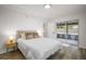 Bright bedroom with neutral tones, hardwood floors, and sliding door access to the patio at 5334 Mary Ann Ln, Orlando, FL 32810