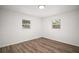 This bedroom features wood-look flooring and two windows allowing for plenty of natural light at 5334 Mary Ann Ln, Orlando, FL 32810
