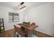 Dining room featuring wood floors, modern light fixture, and table set for four at 5334 Mary Ann Ln, Orlando, FL 32810