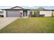 Charming single-story home featuring a well-maintained lawn, gray two car garage door, and attractive curb appeal at 5334 Mary Ann Ln, Orlando, FL 32810