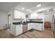 Updated kitchen boasts white cabinets, stainless steel appliances, and sleek countertops at 5334 Mary Ann Ln, Orlando, FL 32810