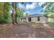Expansive backyard featuring a serene outdoor space, perfect for relaxation and entertaining with mature trees surrounding the property at 57 Pine Trace Crse, Ocala, FL 34472