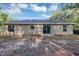 A view of the home's exterior with sliding glass doors that lead to a spacious backyard at 57 Pine Trace Crse, Ocala, FL 34472