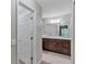 A bright bathroom featuring a granite-topped vanity and neutral tile floor at 57 Pine Trace Crse, Ocala, FL 34472