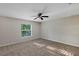 Bright, carpeted bedroom with a large window at 57 Pine Trace Crse, Ocala, FL 34472