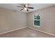 A cozy carpeted bedroom offers natural light and a ceiling fan at 57 Pine Trace Crse, Ocala, FL 34472