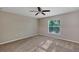 A cozy carpeted bedroom offers natural light and a ceiling fan at 57 Pine Trace Crse, Ocala, FL 34472