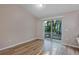 Dining area with wood-style floors and sliding glass doors to backyard with wooded views at 57 Pine Trace Crse, Ocala, FL 34472